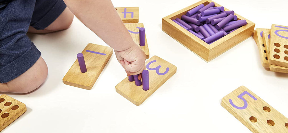 Toddler placing pegs into a wooden Montessori counting board, hands-on learning in the age of AI