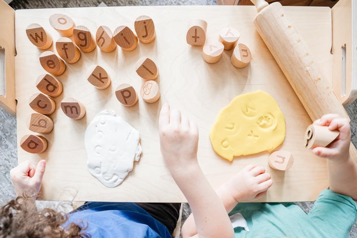 Children using Montessori Alphabet Stamps with dough